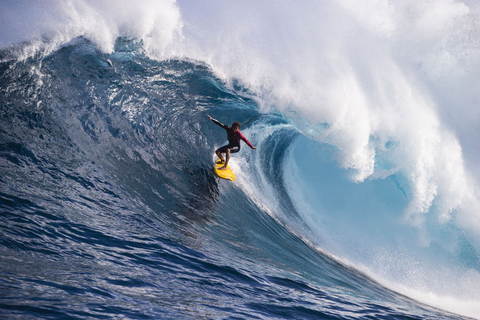 Male surfer surfing wave in Pacific Ocean, Peahi, Hawaii, USA