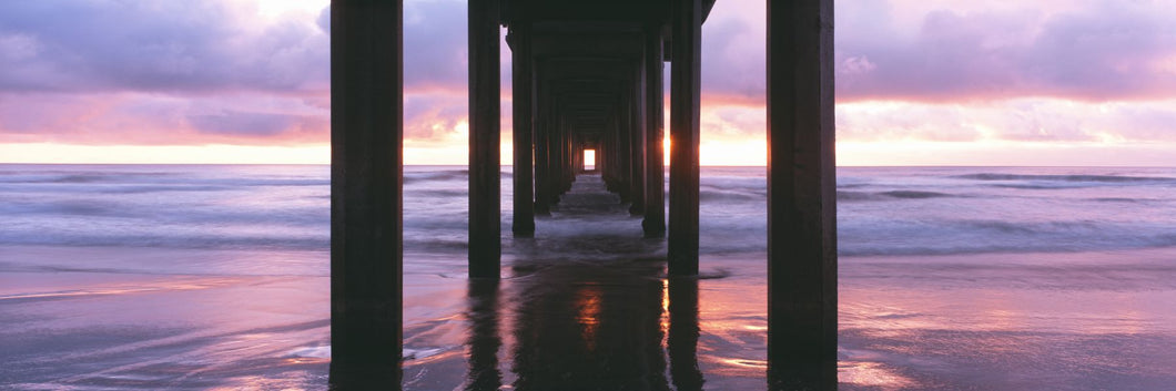 Sunrise over the Pacific Ocean seen from under Scripps Pier, La Jolla Shores Beach, La Jolla, San Diego County, California, USA