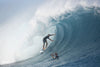 Surfer surfing wave in Pacific Ocean, Moorea, Tahiti, French Polynesia