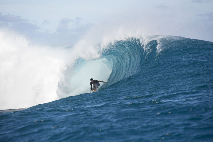 Surfer surfing wave in Pacific Ocean, Moorea, Tahiti, French Polynesia