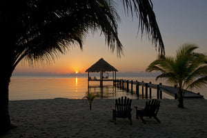 Pier with palapa on Caribbean Sea at sunrise, Maya Beach, Stann Creek District, Belize