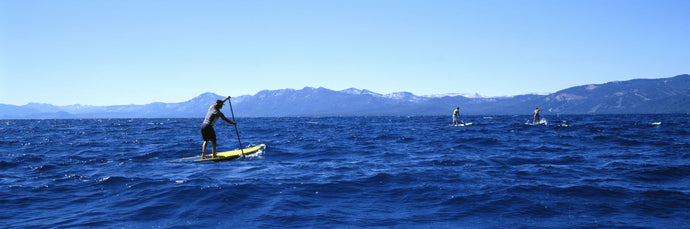 Tourists paddle boarding in a lake, Lake Tahoe, California, USA