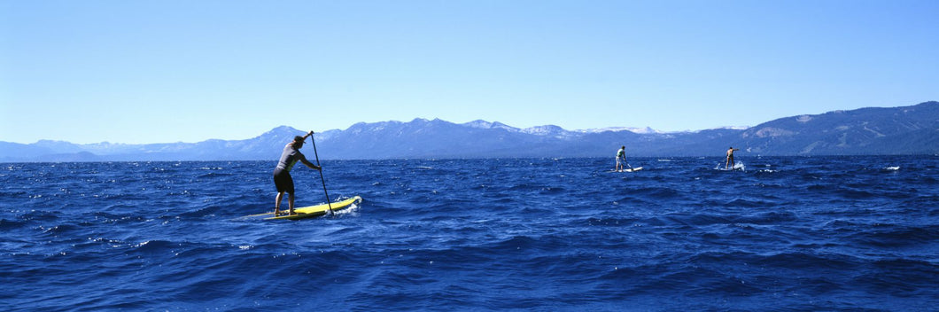 Tourists paddle boarding in a lake, Lake Tahoe, California, USA