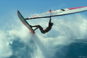 Windsurfer jumping over wave