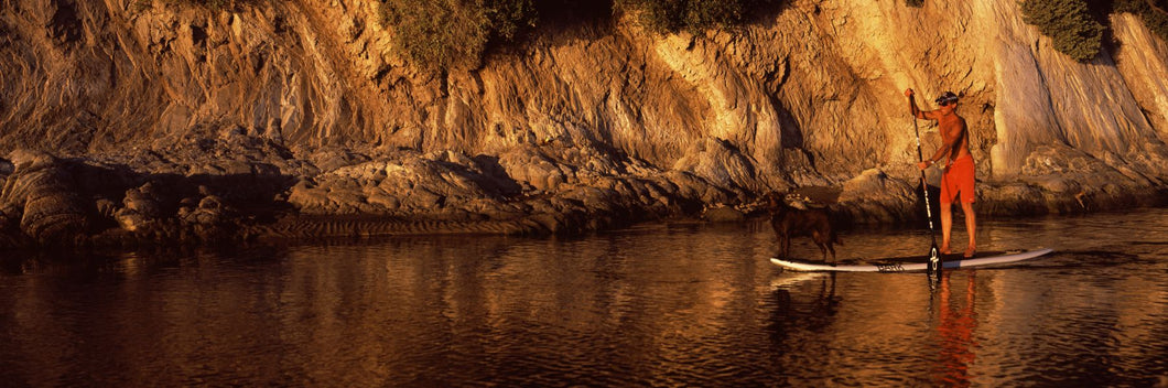 Paddle-boarder in river, Santa Barbara, California, USA