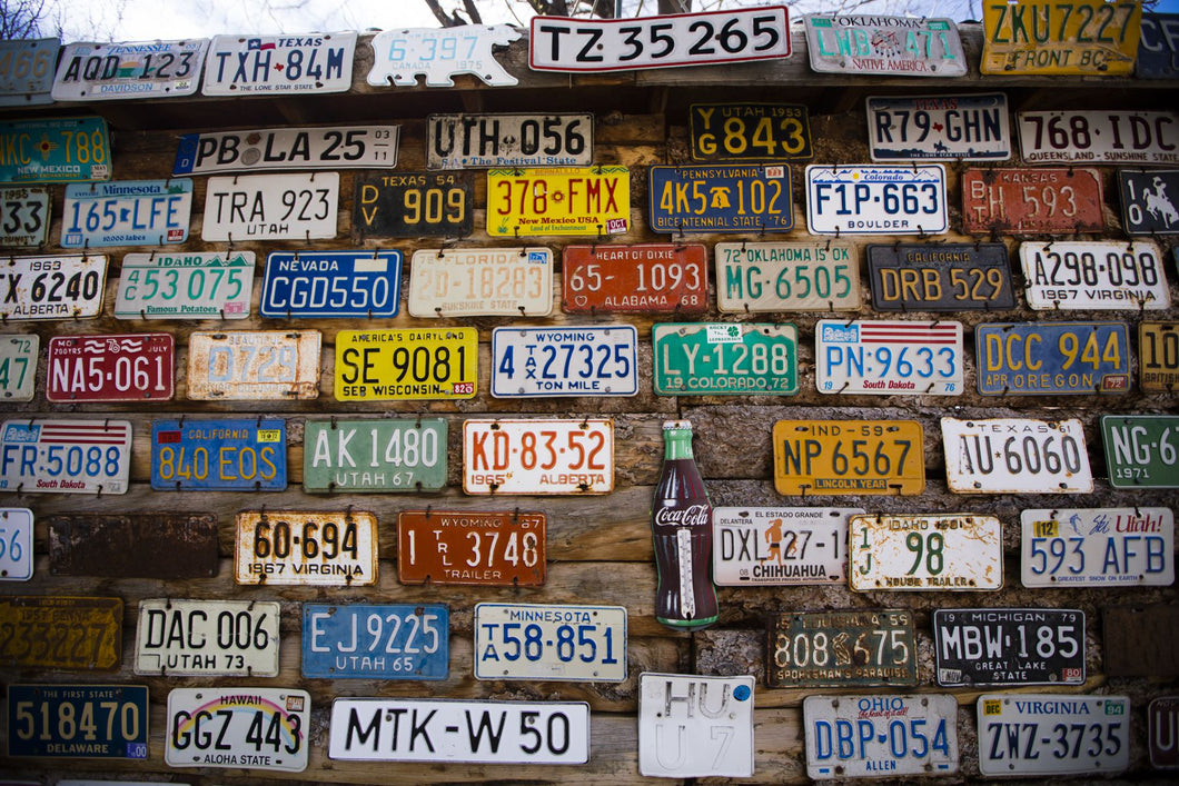License plate mounted on a wall at the roadside, Hole 'N the Rock, Zion National Park, Utah, USA