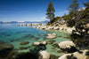 Rocks in a lake with mountain range in the background, Lake Tahoe, California, USA