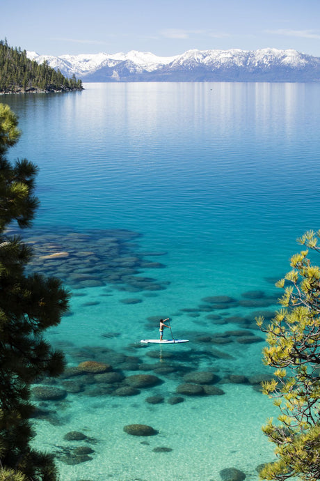 Man paddle boarding in a lake, Lake Tahoe, California, USA