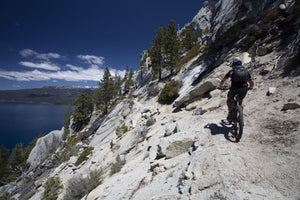 Cyclist on mountain road, Lake Tahoe, California, USA