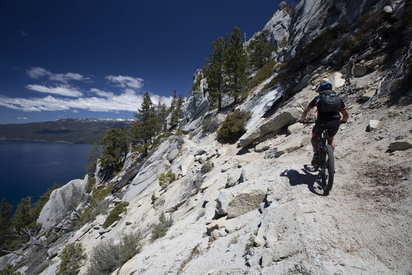 Cyclist on mountain road, Lake Tahoe, California, USA