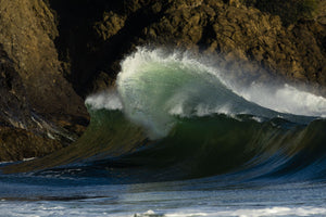 Wave crashing over rocky shore, Cape Disappointment State Park, Washington, USA