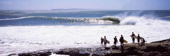 Silhouette of surfers standing on the beach, Australia