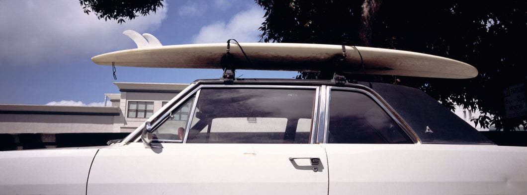 USA, California, Surf board on roof of car