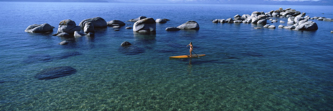 Woman paddle boarding in a lake, Lake Tahoe, California, USA