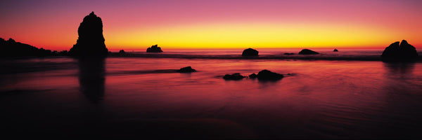 Sunset over rocks in the ocean, Big Sur, California, USA
