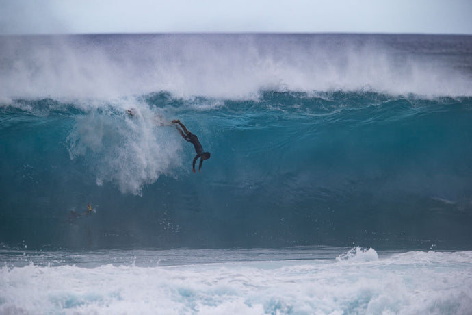 Surfer falling off into breaking wave, Hawaii, USA