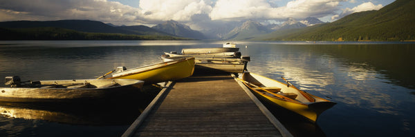 Boats moored at a dock, McDonald Lake, US Glacier National Park, Montana, USA